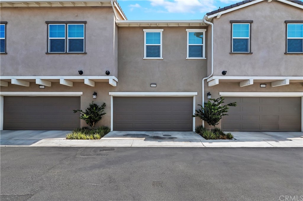 14557 Sienna Place Eastvale, CA 92880 - Photo 30 of 35 a front view of a house with yard