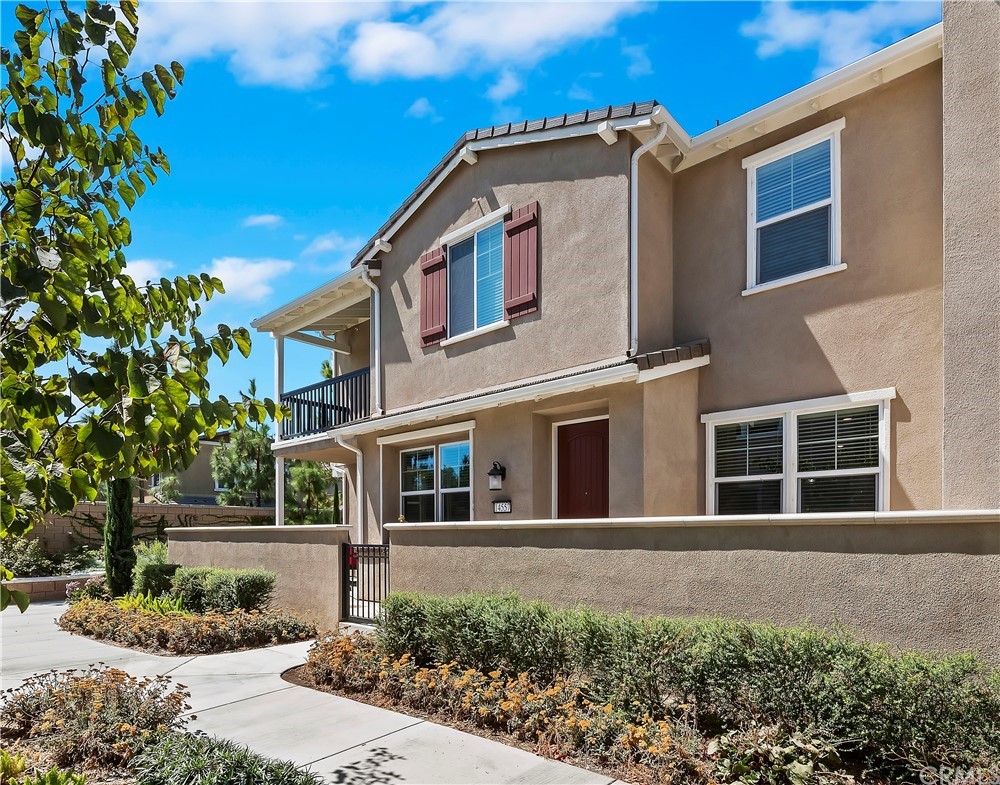 14557 Sienna Place Eastvale, CA 92880 - Photo 3 of 35 a front view of a house with a yard