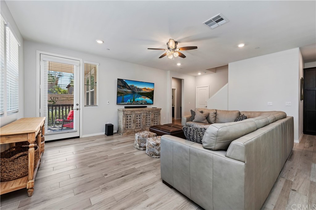 14557 Sienna Place Eastvale, CA 92880 - Photo 7 of 35 a living room with furniture and a flat screen tv
