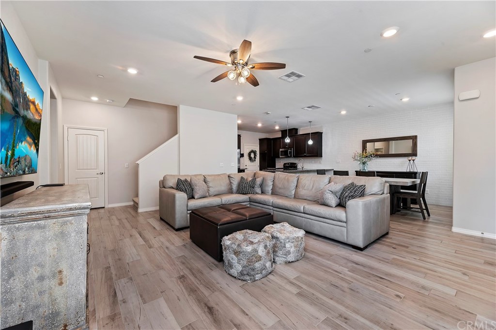 14557 Sienna Place Eastvale, CA 92880 - Photo 8 of 35 a living room with furniture and wooden floor