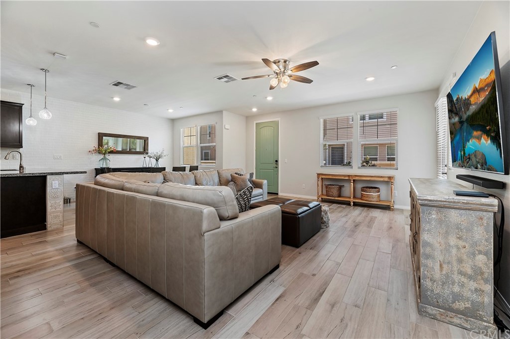14557 Sienna Place Eastvale, CA 92880 - Photo 9 of 35 a living room with furniture and a flat screen tv