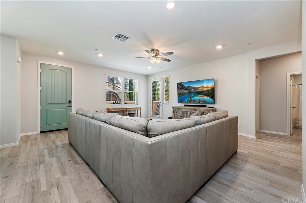 14557 Sienna Place Eastvale, CA 92880 - Photo 10 of 35 a living room with furniture and a flat screen tv