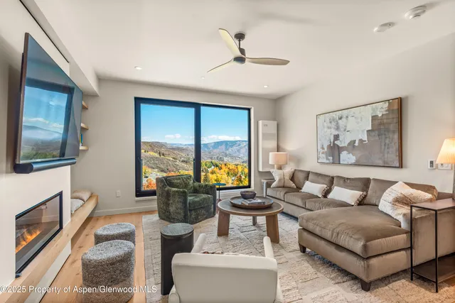 a living room with fireplace furniture and a flat screen tv