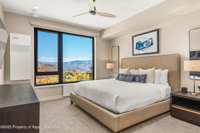 a large bedroom with a large bed and a large window