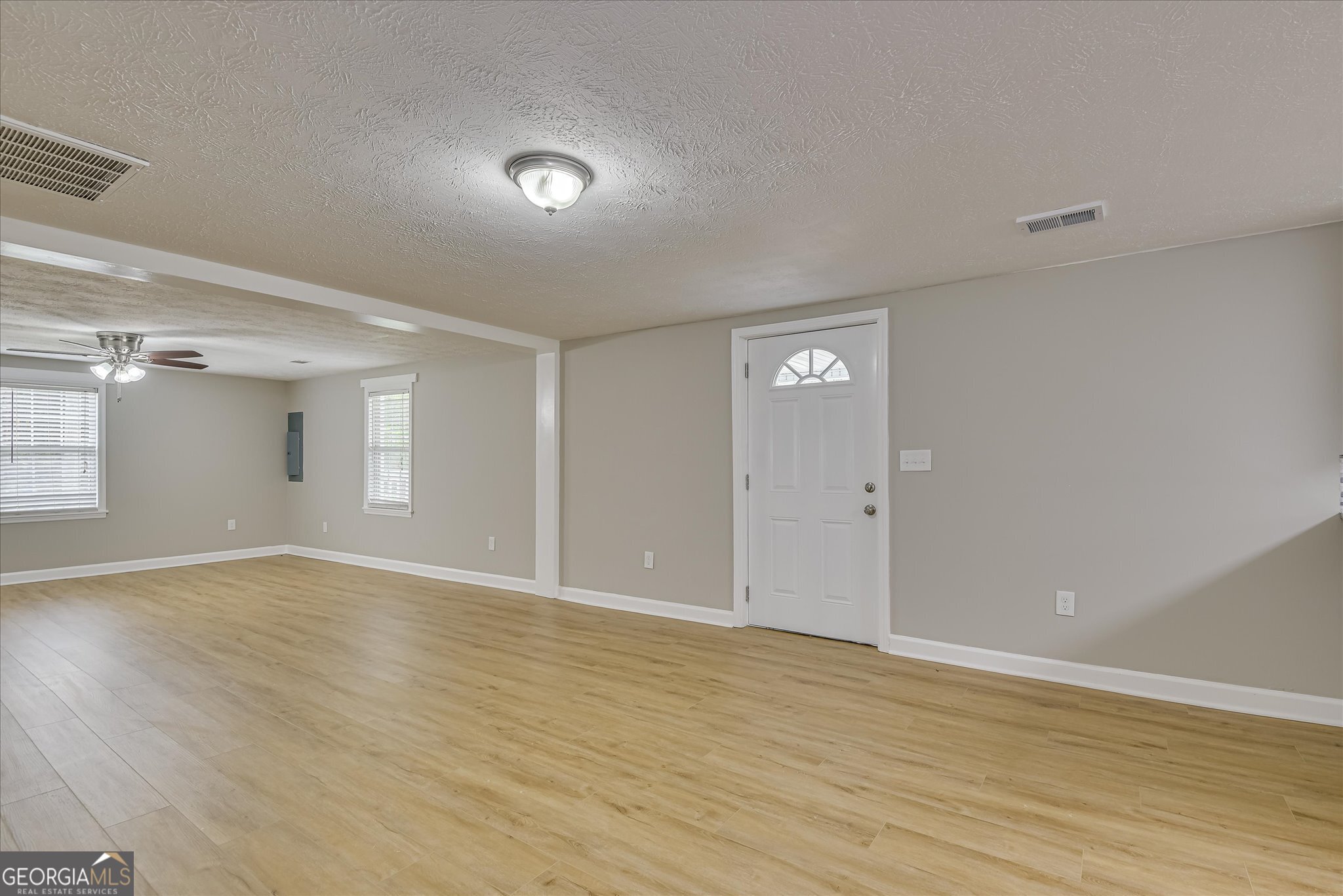 1321 Brett Road Wadley, GA 30477 - Photo 11 of 47 a view of an empty room with wooden floor and a window
