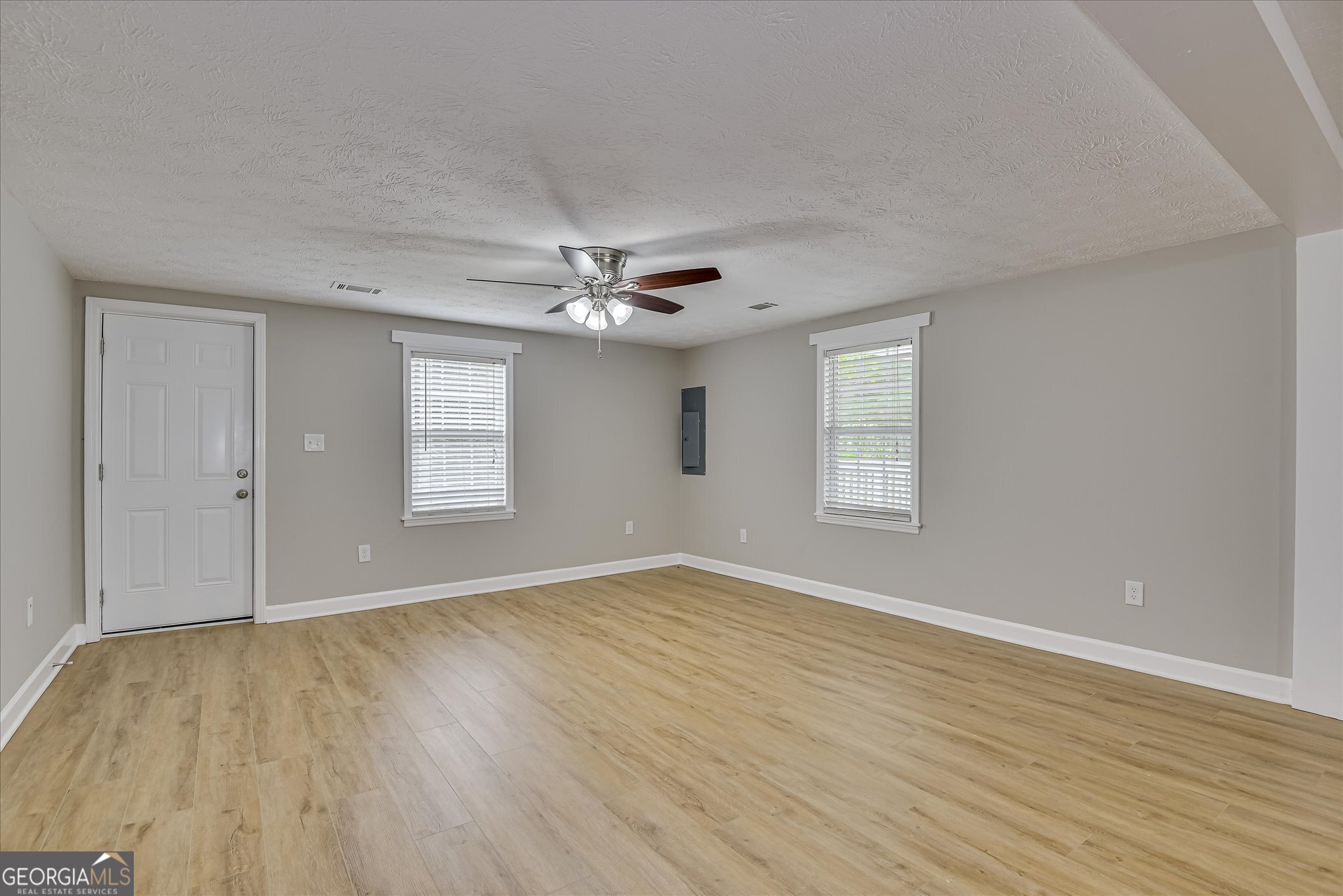 1321 Brett Road Wadley, GA 30477 - Photo 15 of 47 a view of an empty room with wooden floor and a window