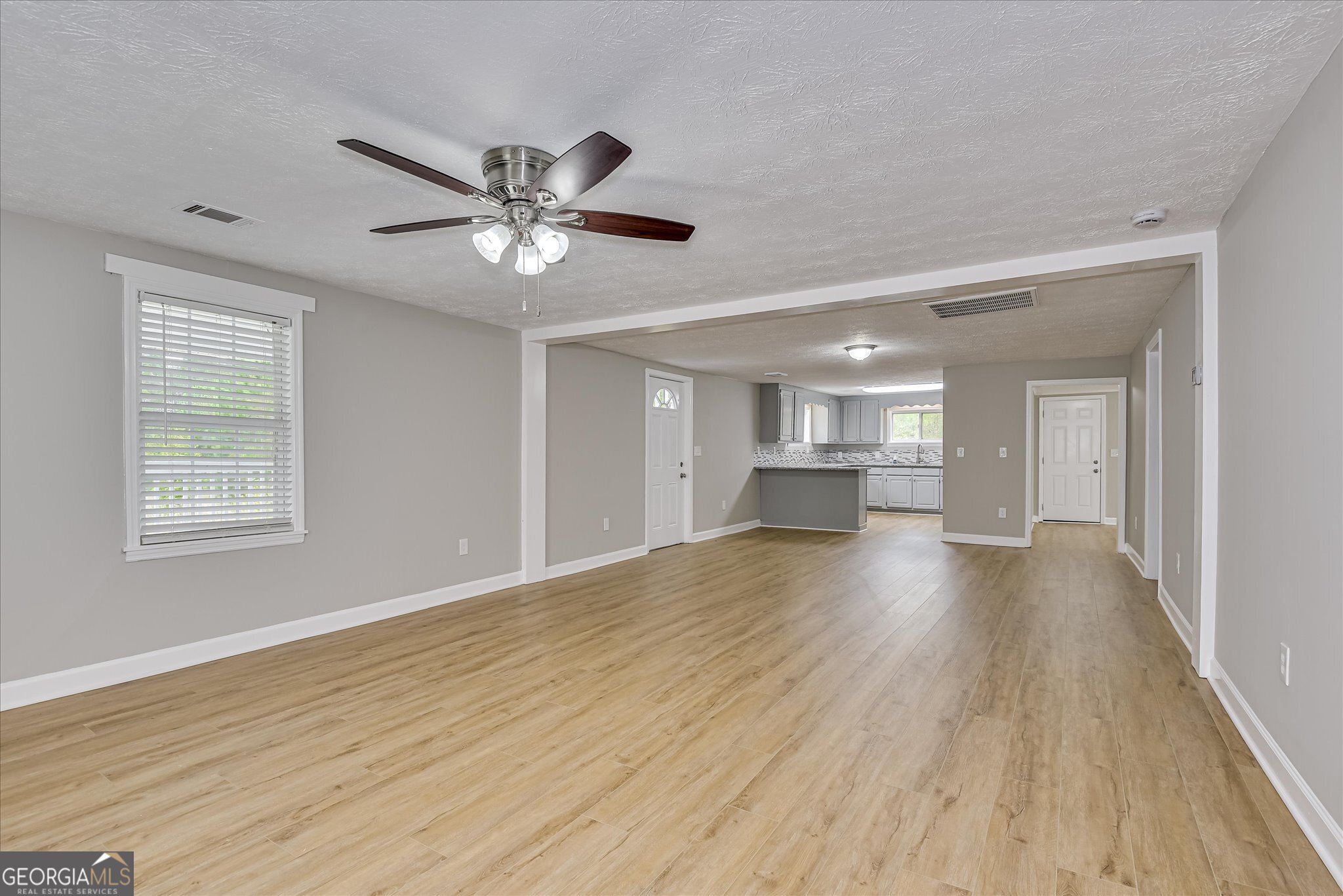 1321 Brett Road Wadley, GA 30477 - Photo 18 of 47 a view of an empty room with window and wooden floor