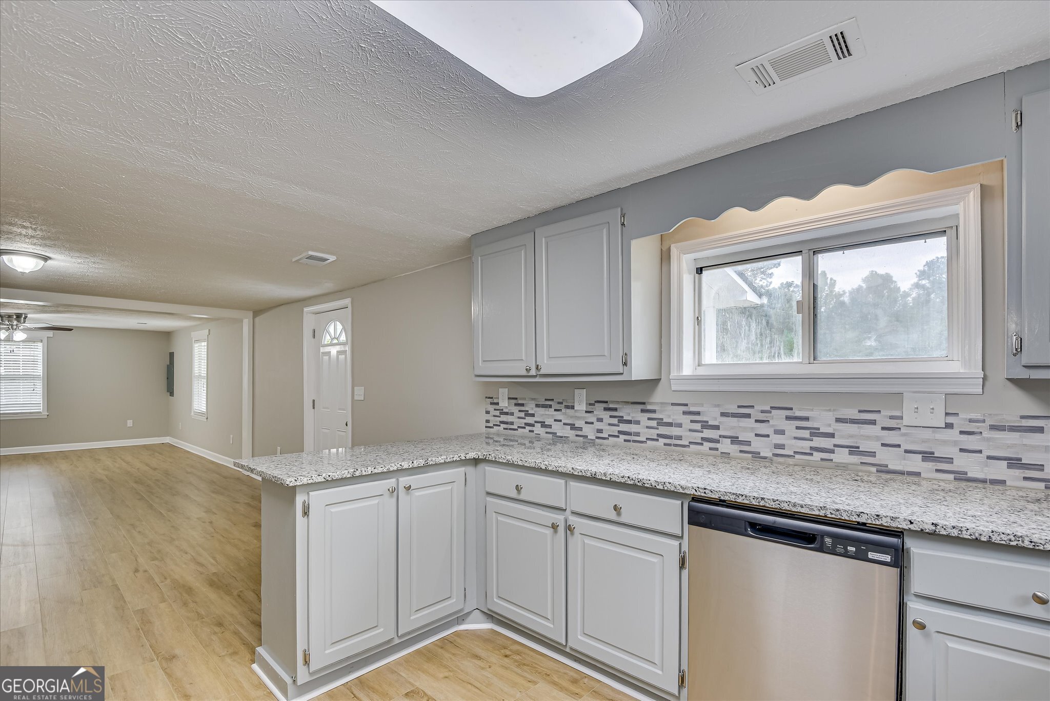 1321 Brett Road Wadley, GA 30477 - Photo 24 of 47 a kitchen with granite countertop a sink and cabinets