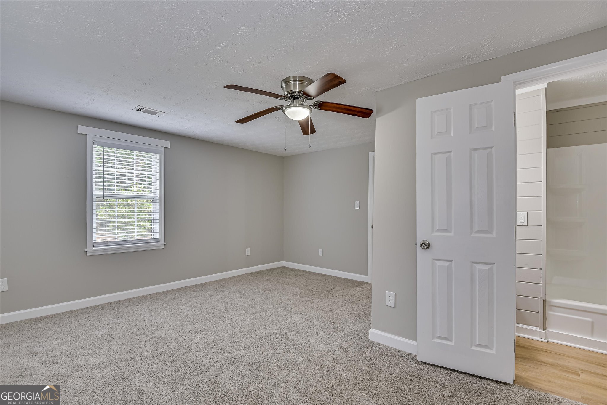 1321 Brett Road Wadley, GA 30477 - Photo 28 of 47 a view of a room with a ceiling fan and a window