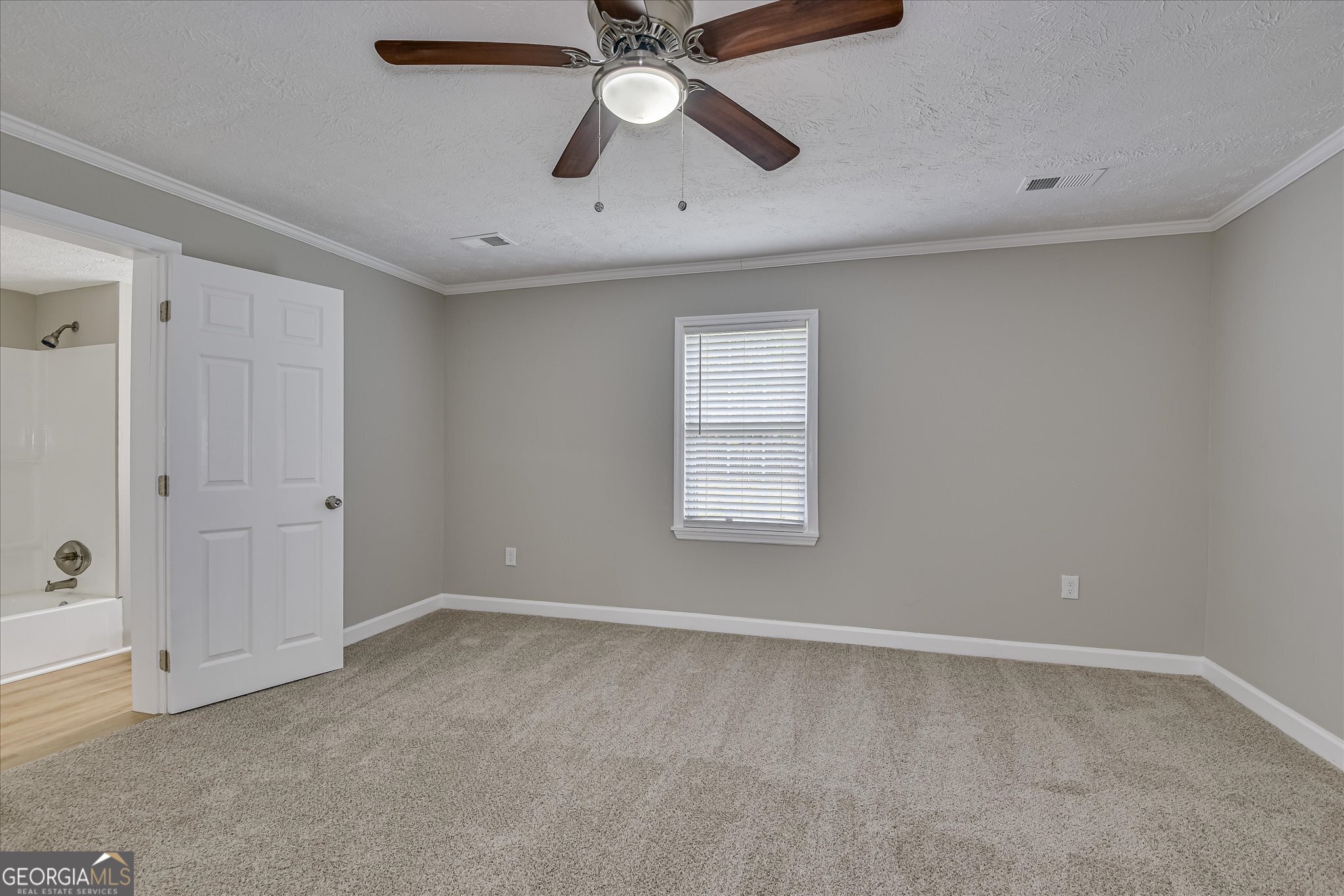 1321 Brett Road Wadley, GA 30477 - Photo 31 of 47 an empty room with ceiling fan and window