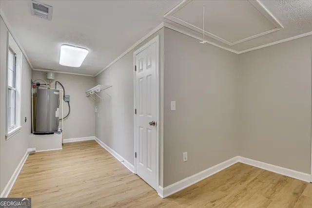 a view of a room with wooden floor and windows
