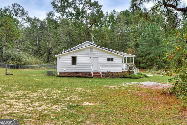 a view of a wooden deck with a big yard