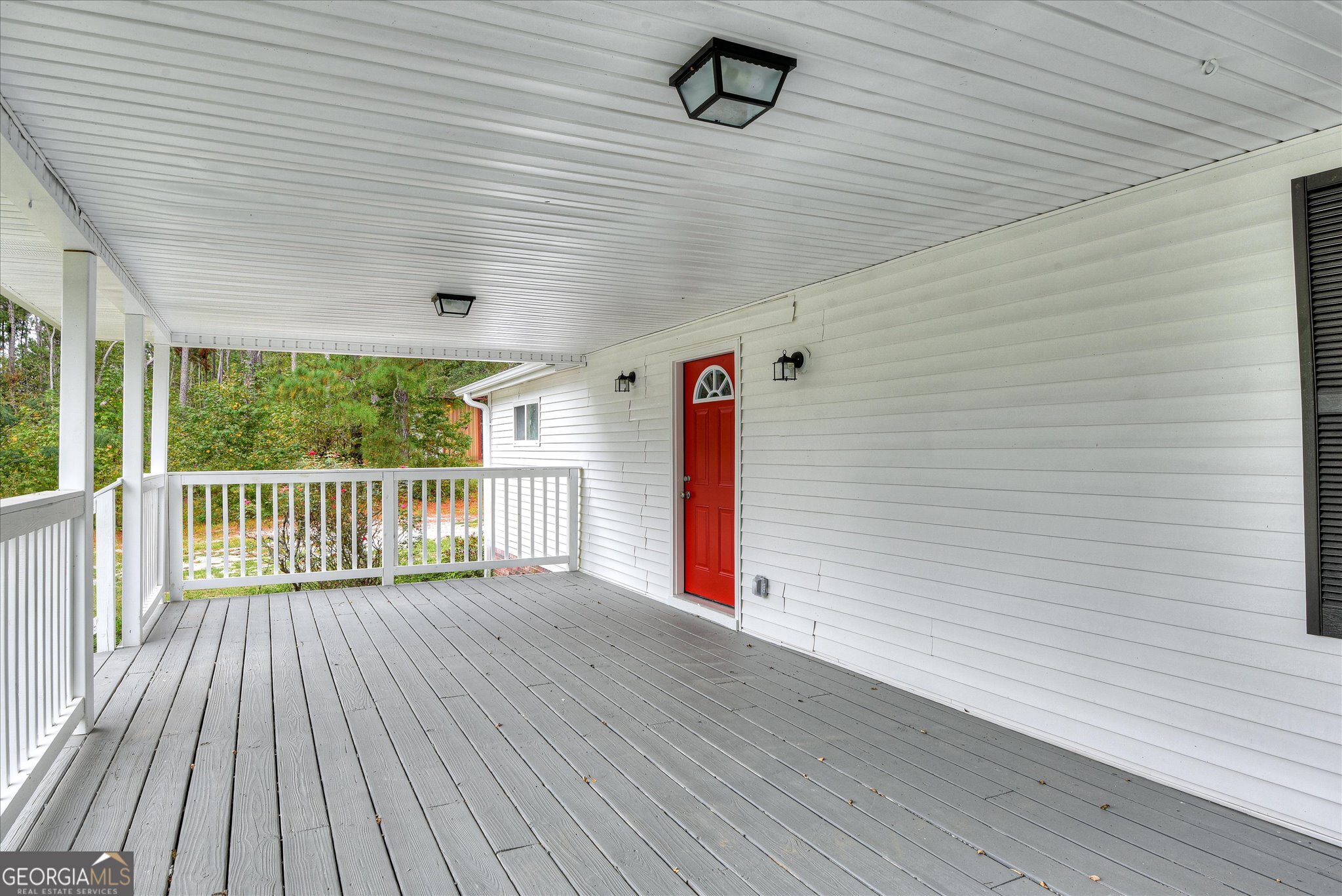 1321 Brett Road Wadley, GA 30477 - Photo 7 of 47 a view of a porch with wooden floor and fence