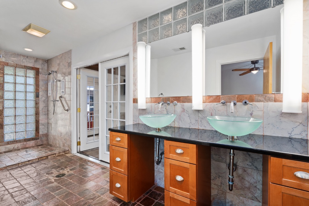 1212 Bentwood Road Austin, TX 78722 - Photo 24 of 32 a bathroom with a granite countertop sink and a mirror