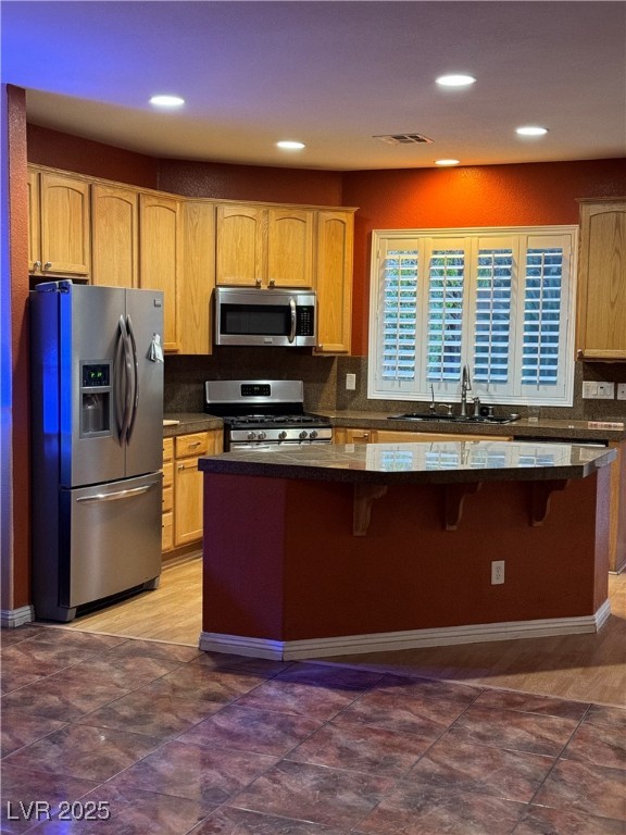 9121 Rusty Rifle Avenue Las Vegas, NV 89143 - Photo 2 of 5 Kitchen with appliances with stainless steel finishes, backsplash, recessed lighting, a breakfast bar, and light brown cabinets
