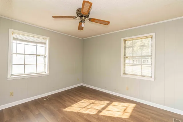 wooden floor in an empty room with a window