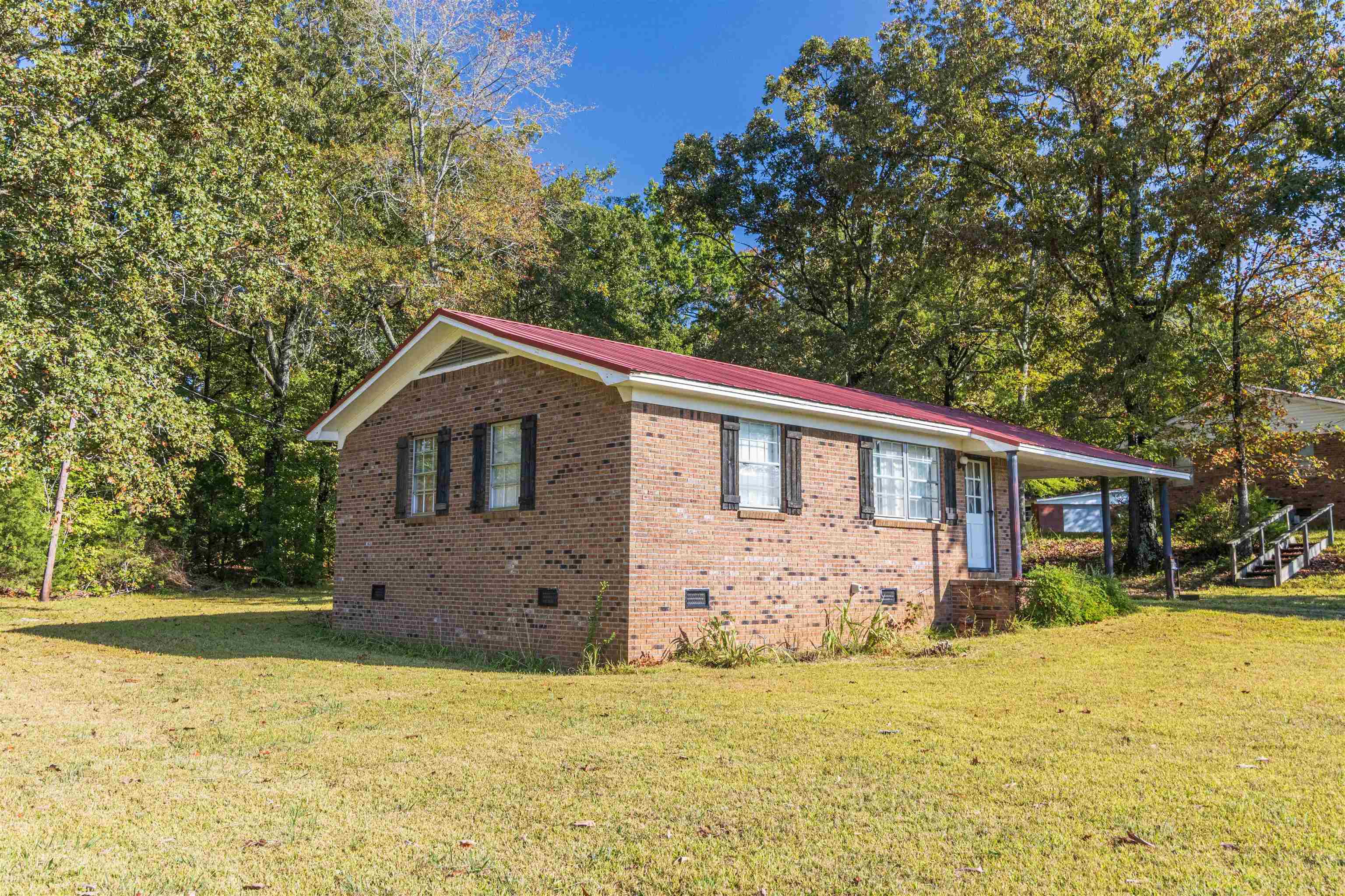147 Jones Street Selmer, TN 38375 - Photo 3 of 19 a front view of house with yard and trees around