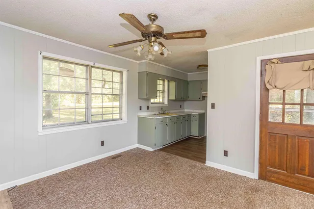 a view of an empty room with a kitchen