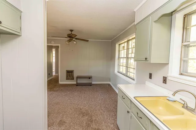 a bathroom with a tub a sink and a window