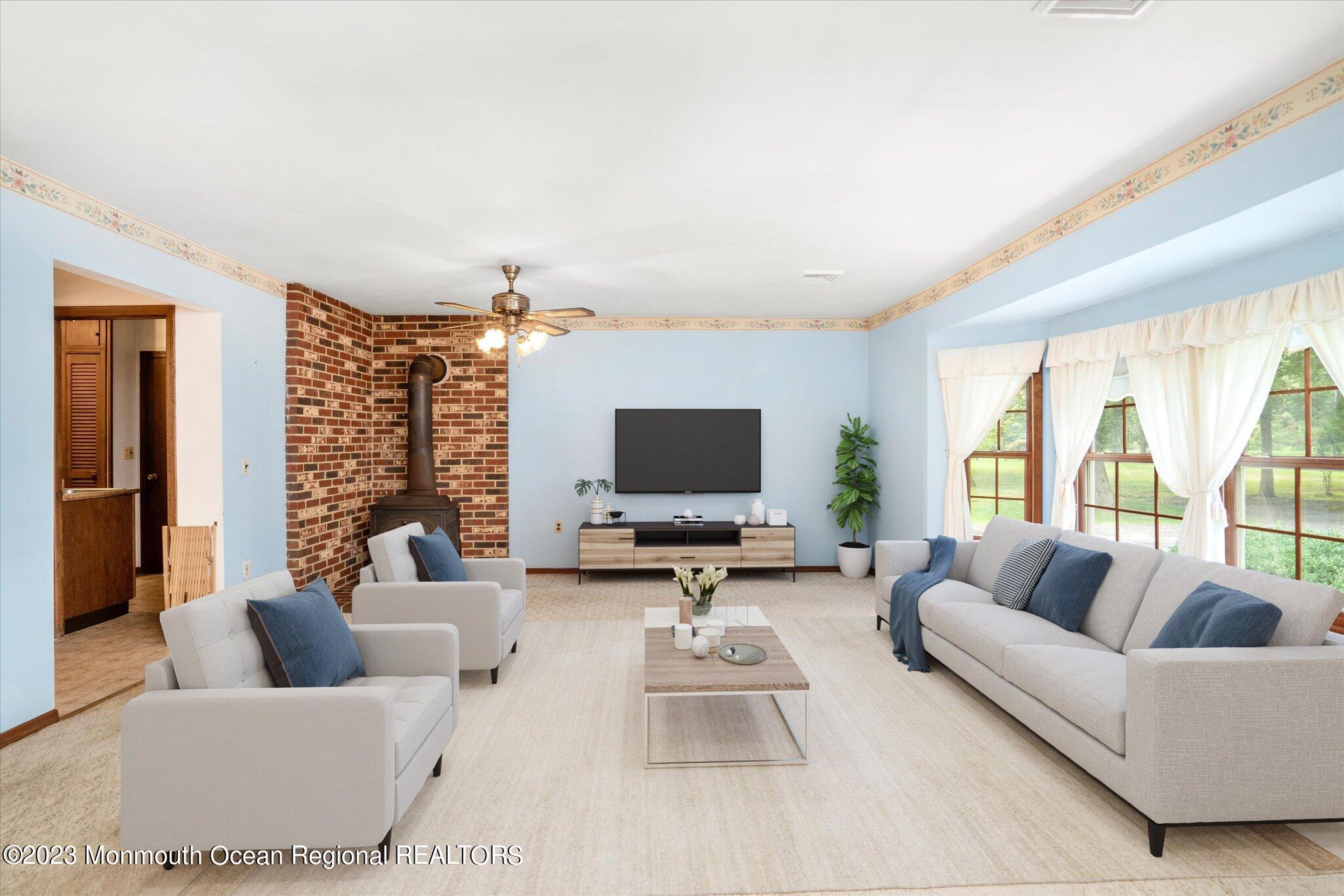 201 West Millstream Road Cream Ridge, NJ 08514 - Photo 11 of 41 a living room with furniture or couch and a flat screen tv