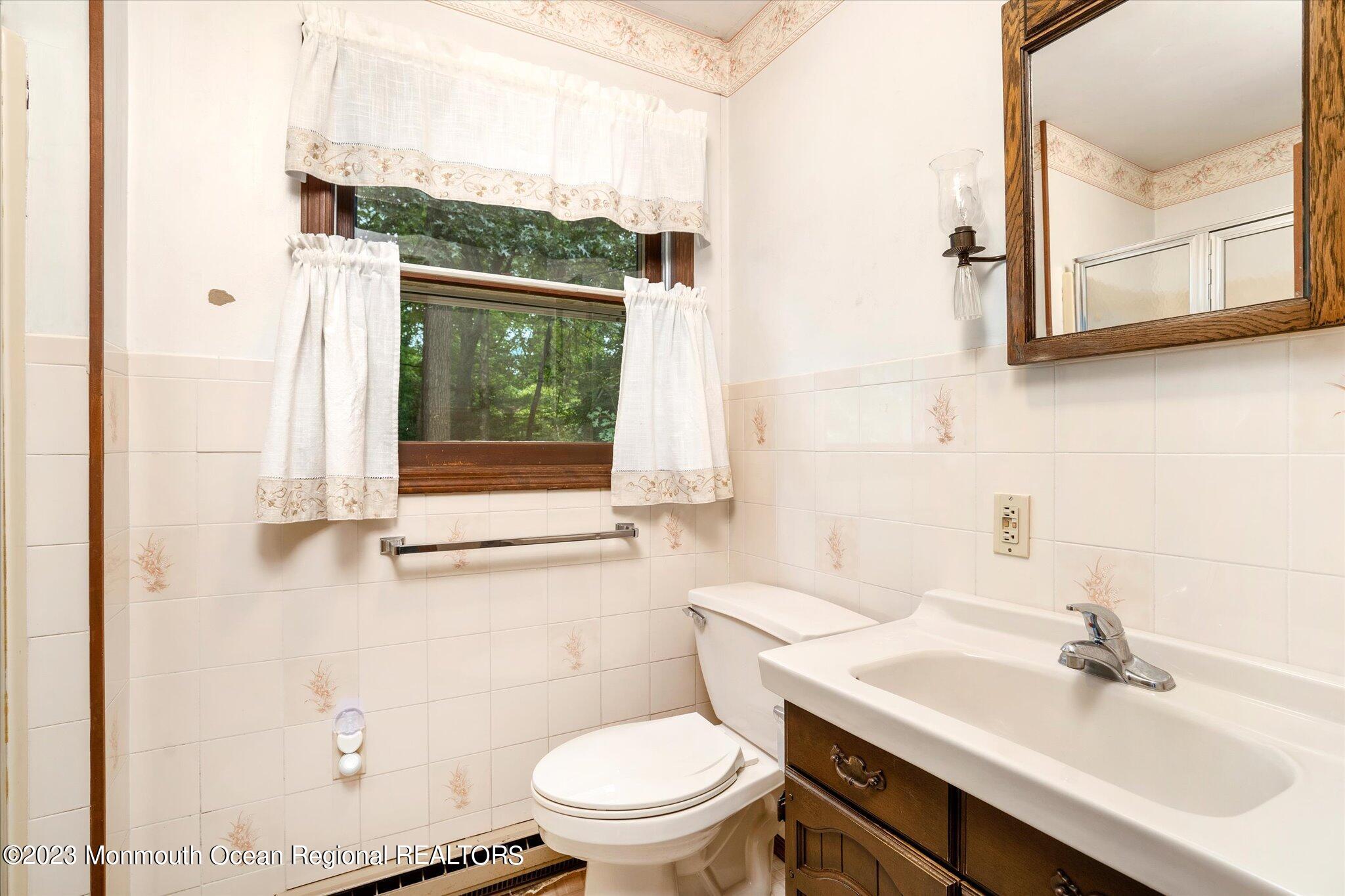 201 West Millstream Road Cream Ridge, NJ 08514 - Photo 25 of 41 a bathroom with a sink a toilet and a mirror