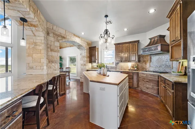 a kitchen with sink stove and cabinets