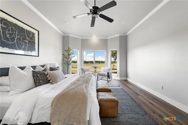 a bedroom with a bed couch and a window