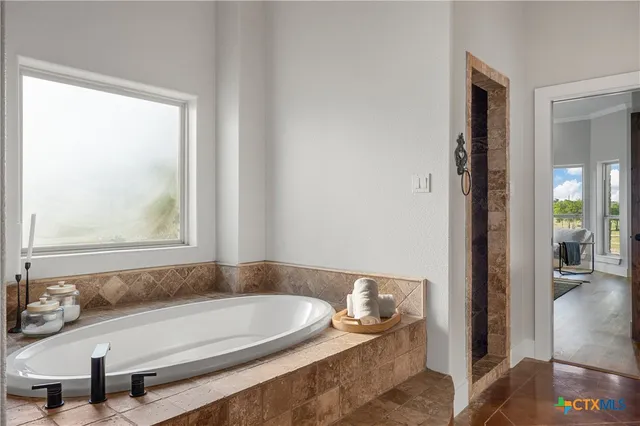 a bath tub sitting next to a window