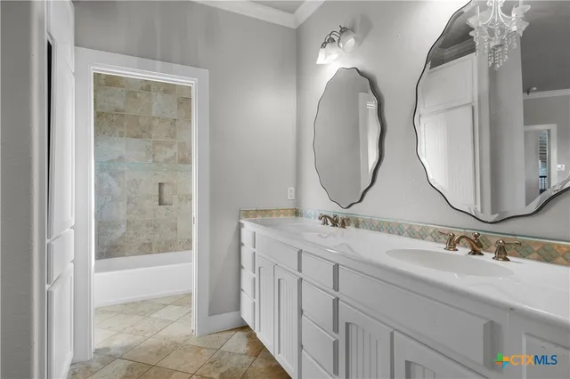a bathroom with a double vanity sink and a mirror