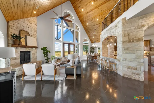 a view of a patio with couches table and chairs and potted plants