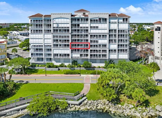 a view of a building with garden space and street view