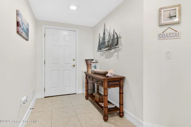 a bedroom with a bed chandelier and a window