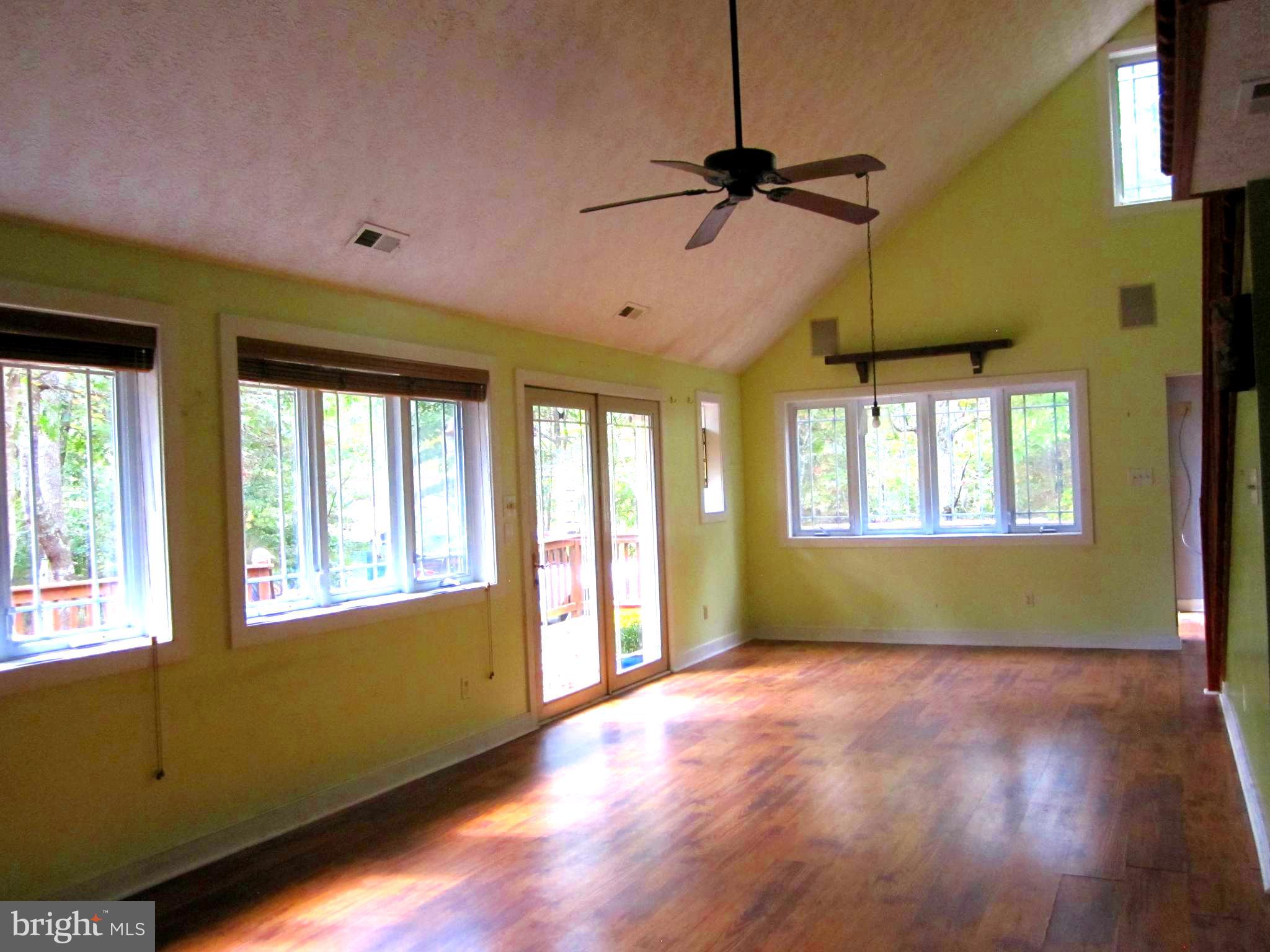 17 Davis Court Basye, VA 22810 - Photo 8 of 18 a view of an empty room with a window and wooden floor