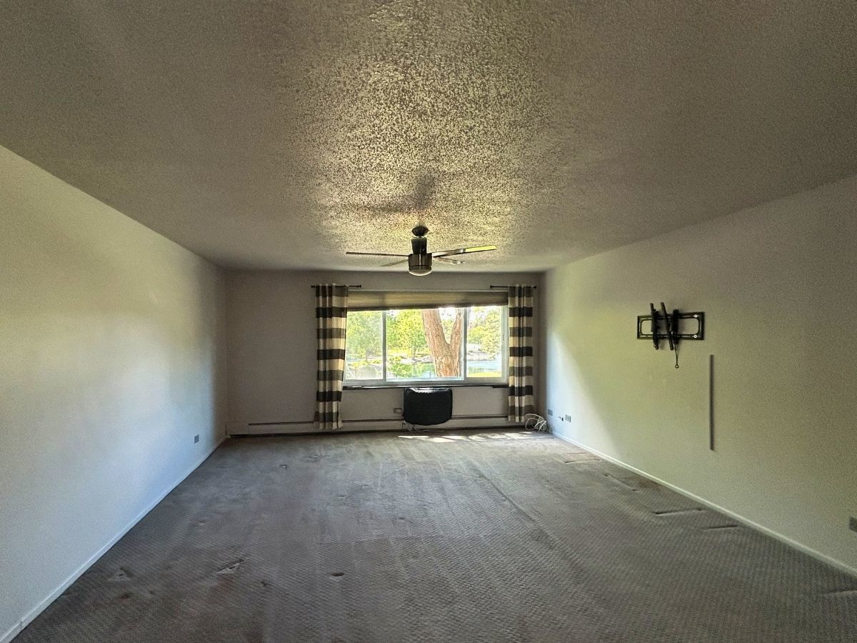 1206 New Wilke Road, Unit 206 Arlington Heights, IL 60005 - Photo 6 of 17 a view of empty room with windows
