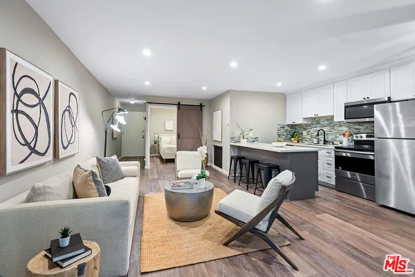 a living room with furniture kitchen and a table