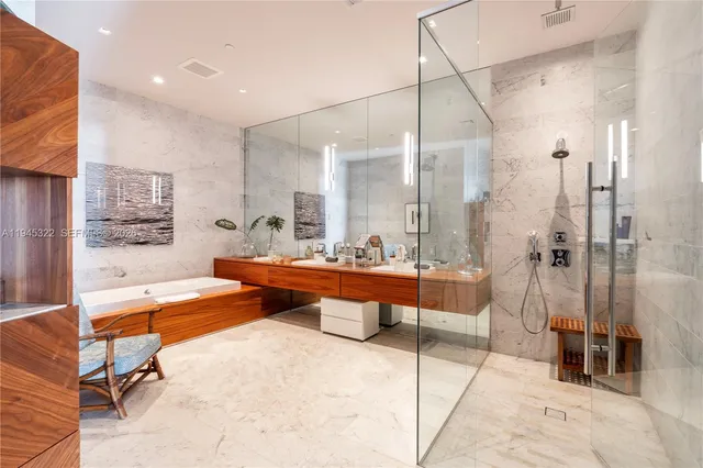 a living room with furniture a rug and a glass door shower