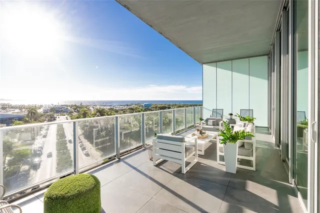 a balcony with furniture and a potted plant