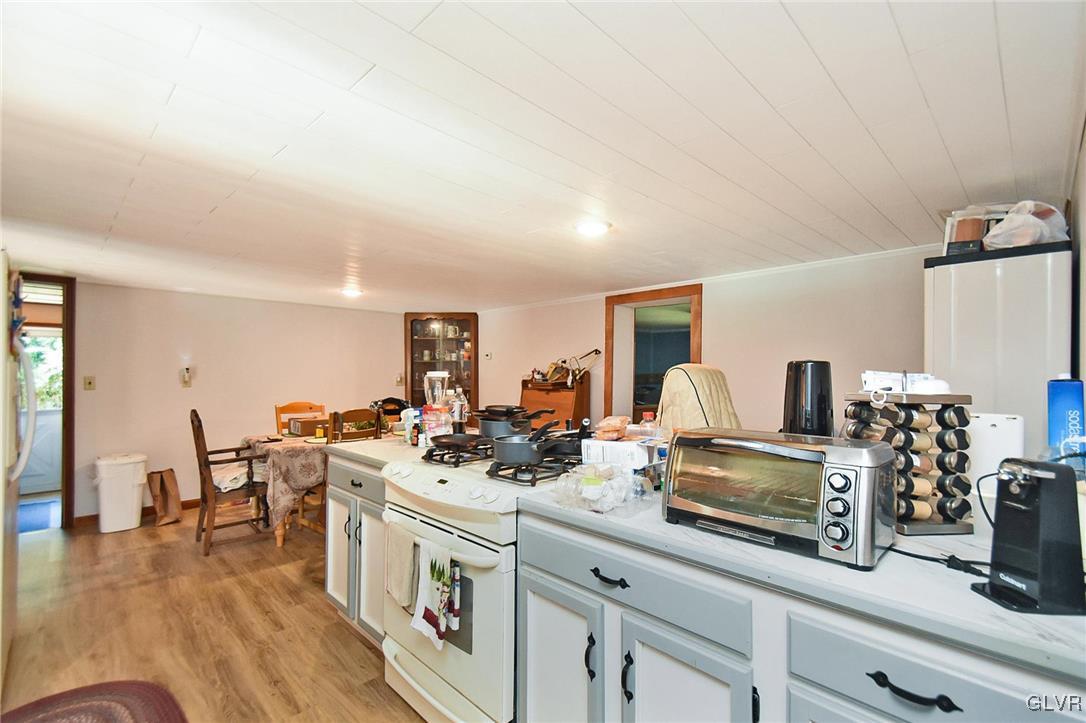 125 Hoffman Road Wind Gap, PA 18091 - Photo 6 of 18 a open kitchen with stainless steel appliances granite countertop a stove and a wooden floors