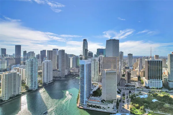 a kitchen with a wooden floor and a refrigerator