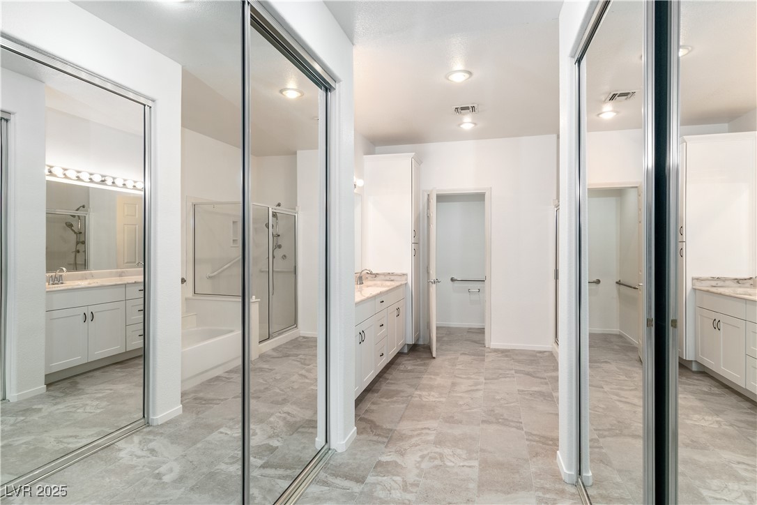 3155 Quail Song Drive Laughlin, NV 89029 - Photo 25 of 85 Bathroom featuring two vanities, a stall shower, a garden tub, and tile flooring