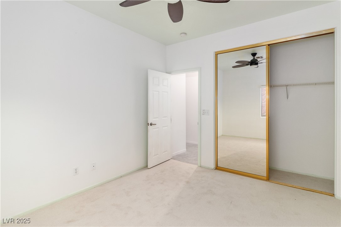 3155 Quail Song Drive Laughlin, NV 89029 - Photo 40 of 85 Third bedroom featuring carpet flooring, a closet, and a ceiling fan