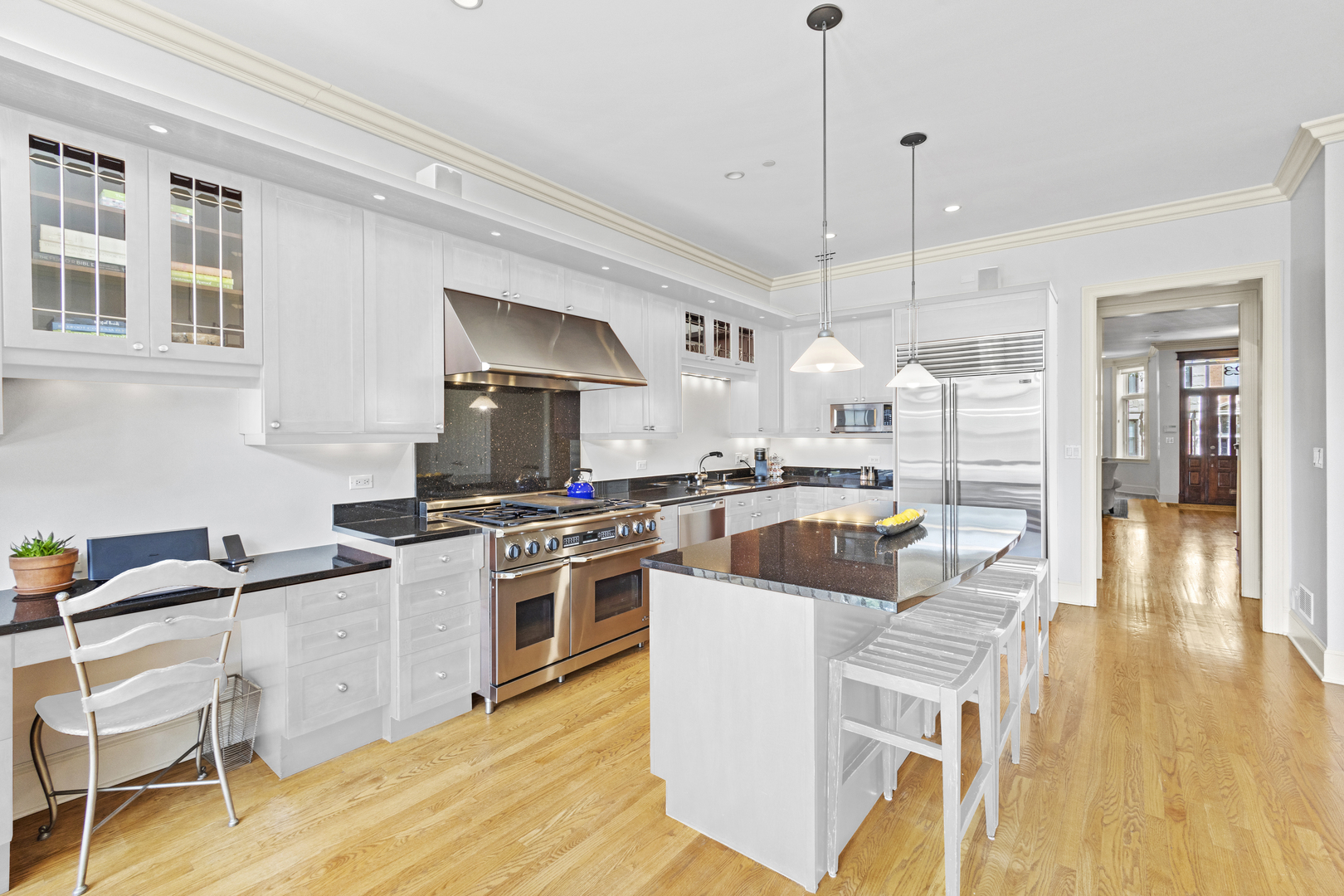 1423 West Lexington Street Chicago, IL 60607 - Photo 12 of 36 a kitchen with stainless steel appliances granite countertop a stove a sink dishwasher and a refrigerator with wooden floor