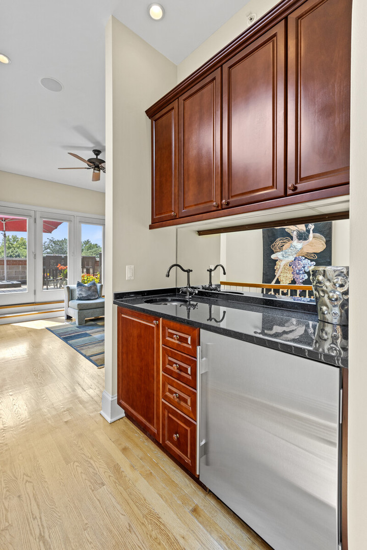 1423 West Lexington Street Chicago, IL 60607 - Photo 25 of 36 a kitchen with stainless steel appliances granite countertop a sink and cabinets