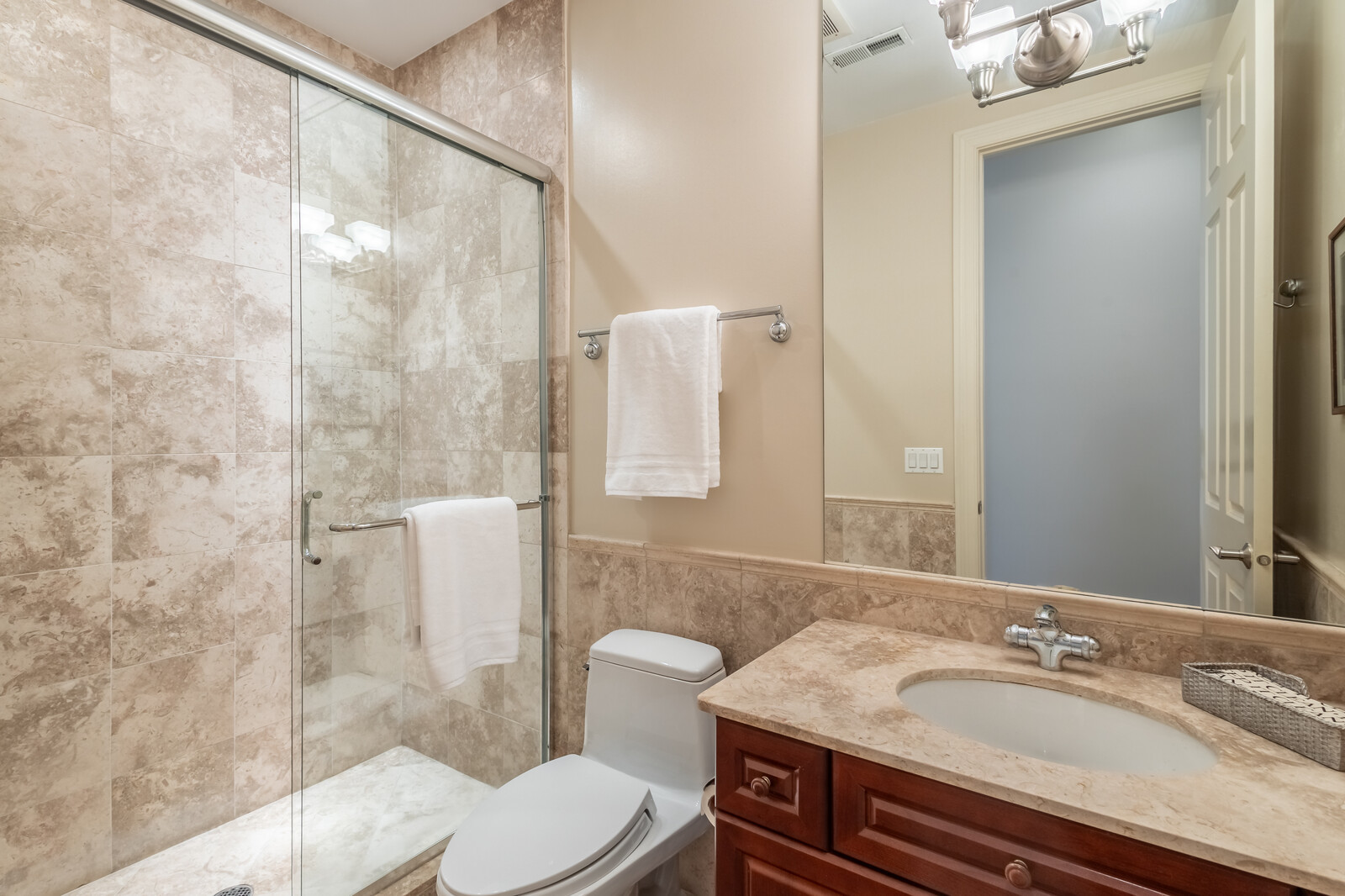 1423 West Lexington Street Chicago, IL 60607 - Photo 27 of 36 a bathroom with a granite countertop sink toilet a mirror and shower