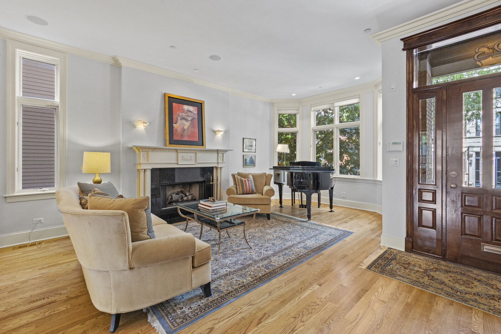1423 West Lexington Street Chicago, IL 60607 - Photo 6 of 36 a living room with furniture a rug wooden floor and a fireplace