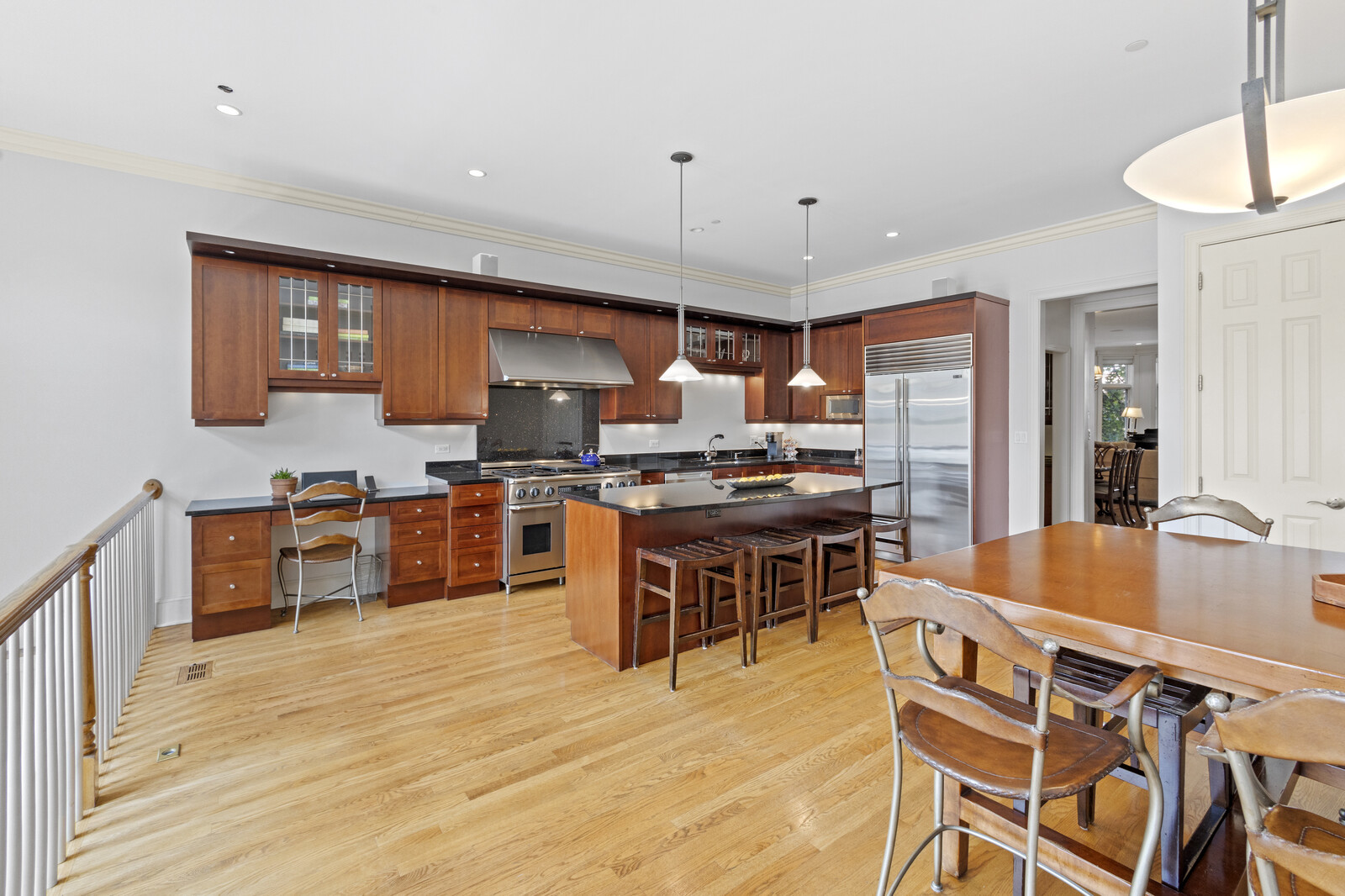 1423 West Lexington Street Chicago, IL 60607 - Photo 9 of 36 a kitchen with stainless steel appliances kitchen island granite countertop a sink cabinets and wooden floor