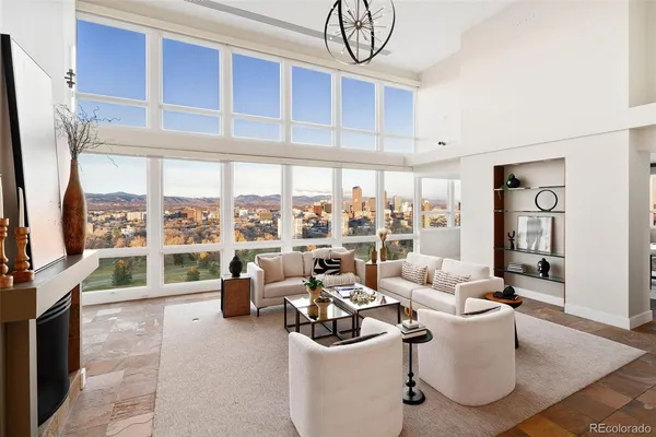 a living room with furniture a floor to ceiling window and a flat screen tv