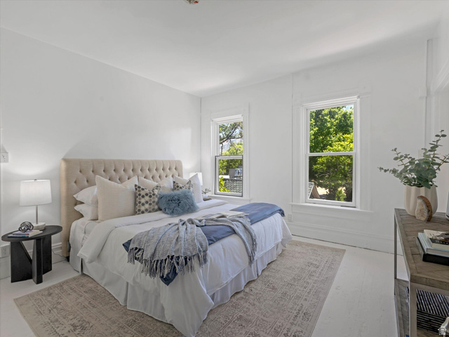 12825 South Fort Street Draper, UT 84020 - Photo 20 of 52 Bright room featuring two large windows with white trim, white walls, and light-toned wood-finish flooring