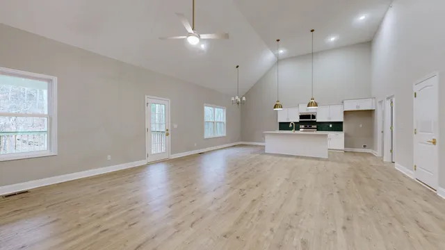 a view of an empty room with window and fire place
