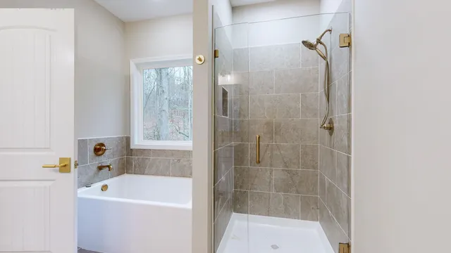 a white bath tub sitting next to a white sink